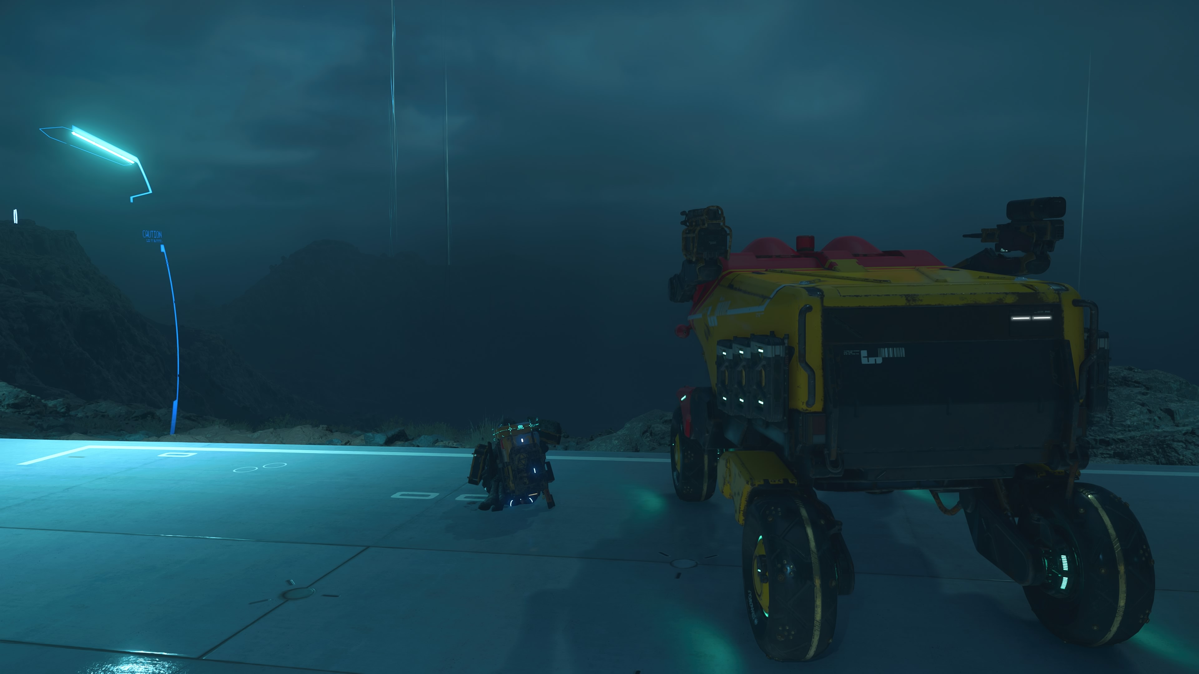 A screenshot of Death Stranding 2. Sam is sat on a road looking out over a foggy, valleyed horizon. His pick-up truck is parked next to him. The image could have been taken anywhere in the game's world, but for me, it was taken somewhere very, very special.